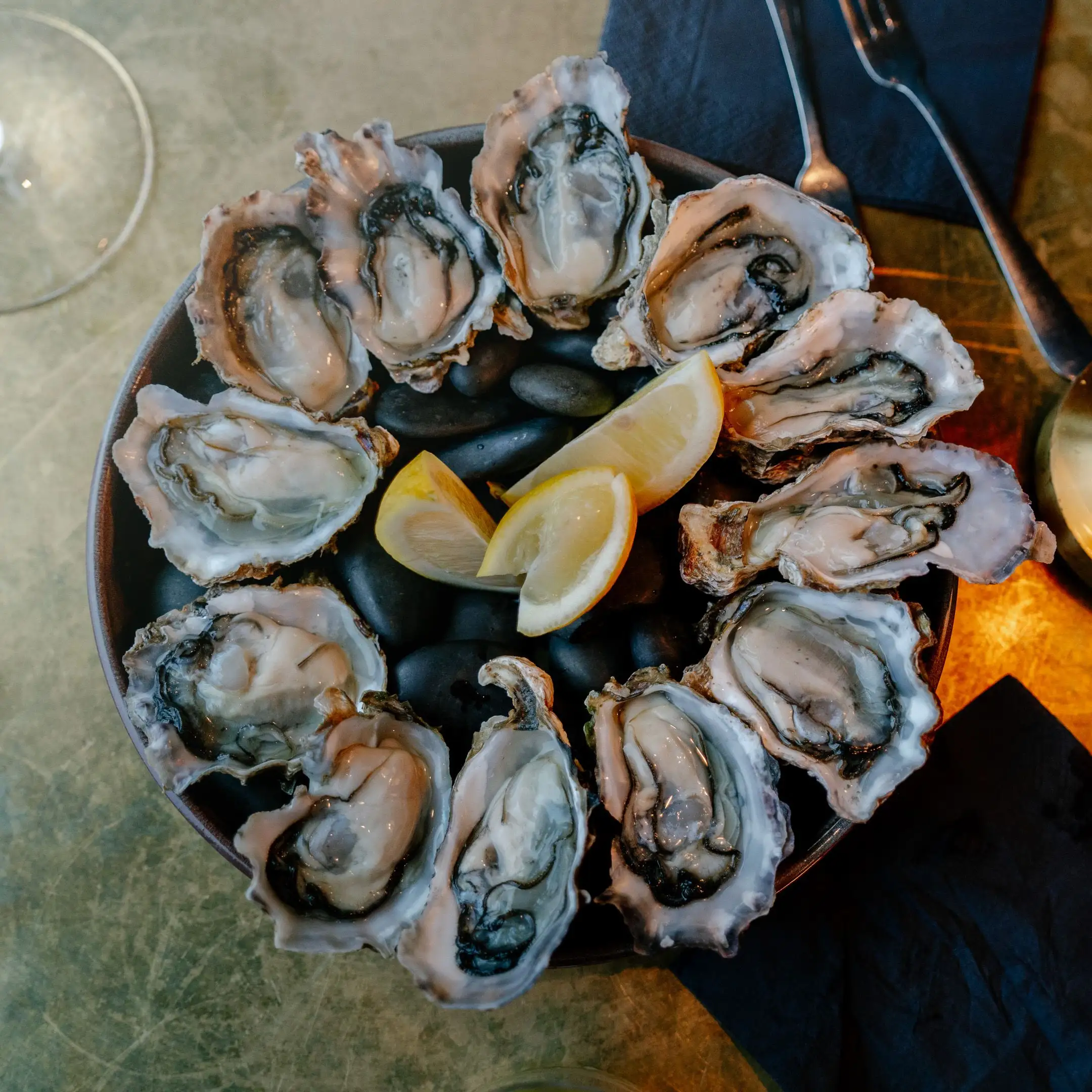 Oysters on the half shell over ice with lemon